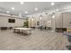 Large meeting room with sleek flooring, neutral walls, television, and tables for gatherings and presentations at 4008 San Gallo Dr # 102, Kissimmee, FL 34741