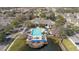 Aerial view of community pool and amenities, adjacent to a tranquil pond at 4008 San Gallo Dr # 102, Kissimmee, FL 34741