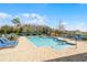 Community pool with blue lounge chairs on a brick patio at 4008 San Gallo Dr # 102, Kissimmee, FL 34741