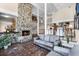 Inviting living room with stone fireplace, terracotta tile, and comfortable grey sofa at 407 W 1St Ave, Windermere, FL 34786