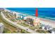 Bright aerial view of a condo complex with ocean views, parking, and a nearby golf course at 4651 S Atlantic Ave # 3060, Ponce Inlet, FL 32127