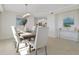 Bright dining room area with ocean views, tile flooring, and stylish furniture at 4651 S Atlantic Ave # 3060, Ponce Inlet, FL 32127