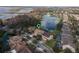 An aerial view of the beautiful neighborhood shows this home is near a lake with fountain views and lush foliage at 4903 Eastlake Vista Dr, St Cloud, FL 34771