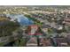 An aerial view of a home and surrounding community with a lake and fountain, showing a well-manicured neighborhood at 4903 Eastlake Vista Dr, St Cloud, FL 34771