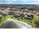 An aerial shot of the home overlooking a beautiful lake with spacious backyard and an inviting screened pool at 4903 Eastlake Vista Dr, St Cloud, FL 34771
