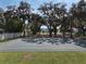 Outdoor basketball court surrounded by mature trees, providing a recreational space within the community at 4903 Eastlake Vista Dr, St Cloud, FL 34771