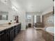 Spacious bathroom features double vanities, a soaking tub, and a walk-in shower at 4903 Eastlake Vista Dr, St Cloud, FL 34771