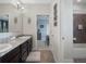 Bathroom showcasing double vanity, granite counters, and a walk-in shower and open to bedroom at 4903 Eastlake Vista Dr, St Cloud, FL 34771