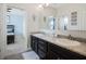 Bathroom with a double sink vanity, granite counters, and modern lighting at 4903 Eastlake Vista Dr, St Cloud, FL 34771