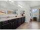 Double vanities, granite countertops, and decorative lighting in this spacious bathroom at 4903 Eastlake Vista Dr, St Cloud, FL 34771