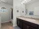 Bathroom with granite countertops, dual sinks, and a shower/tub combo at 4903 Eastlake Vista Dr, St Cloud, FL 34771