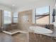 Bathroom featuring a modern tub, a glass enclosed shower, and natural light at 4903 Eastlake Vista Dr, St Cloud, FL 34771