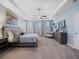 Spacious bedroom with trey ceiling, ceiling fan, windows, chaise, and dresser at 4903 Eastlake Vista Dr, St Cloud, FL 34771
