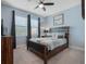 Bedroom with a ceiling fan, window with blinds and curtains and nice decor at 4903 Eastlake Vista Dr, St Cloud, FL 34771