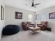 Media room with leather seating, overhead fan, and natural light at 4903 Eastlake Vista Dr, St Cloud, FL 34771