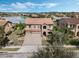A beautiful home featuring a barrel tile roof, brick driveway, lush landscaping, and a two-car garage at 4903 Eastlake Vista Dr, St Cloud, FL 34771