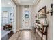 Bright foyer featuring decorative glass door, tile flooring, and wood console table at 4903 Eastlake Vista Dr, St Cloud, FL 34771