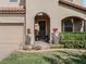 A charming front entrance with decorative plants, a manicured lawn, and a covered doorway at 4903 Eastlake Vista Dr, St Cloud, FL 34771