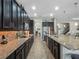 Gourmet kitchen featuring granite countertops, stainless steel appliances, and dark wood cabinetry at 4903 Eastlake Vista Dr, St Cloud, FL 34771