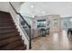 Inviting living room with staircase, large windows overlooking the lake, and tray ceiling at 4903 Eastlake Vista Dr, St Cloud, FL 34771