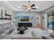 Spacious living room with coffered ceiling, large sectional sofa, and lake views at 4903 Eastlake Vista Dr, St Cloud, FL 34771