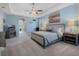 Spacious main bedroom featuring light blue walls, trey ceilings, and neutral toned furniture and decor at 4903 Eastlake Vista Dr, St Cloud, FL 34771