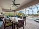 Enjoy outdoor dining and lounging by the pool on this screened patio with lake views at 4903 Eastlake Vista Dr, St Cloud, FL 34771