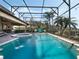 Stunning pool and spa area with fountains, surrounded by lush landscaping in a screened enclosure at 4903 Eastlake Vista Dr, St Cloud, FL 34771