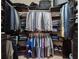 Organized walk-in closet with clothing racks, shelving, and suitcase storage at 4903 Eastlake Vista Dr, St Cloud, FL 34771