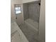 Modern bathroom with tub, shower combination, white cabinets, and marble floors at 50 Avalon Ct, Casselberry, FL 32707