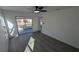 Bright bedroom featuring sleek gray floors and sliding glass doors to the outside at 50 Avalon Ct, Casselberry, FL 32707