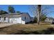 Side view of home showcasing white exterior paint and well-kept landscaping at 50 Avalon Ct, Casselberry, FL 32707