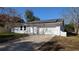 Bright exterior of home featuring a large driveway and a two-car garage door at 50 Avalon Ct, Casselberry, FL 32707