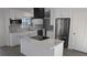 Modern kitchen with white cabinets, stainless steel appliances, and spacious kitchen island at 50 Avalon Ct, Casselberry, FL 32707