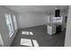 Open-concept living room and kitchen area with luxury vinyl plank flooring and ample natural light at 50 Avalon Ct, Casselberry, FL 32707