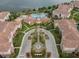 An aerial view of a lovely residential community with a luxurious pool area, fountains, lush greenery, and a tranquil lake nearby at 5076 Tideview Cir # 90, Orlando, FL 32819