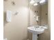 Bathroom with white pedestal sink and decorative mirror at 5076 Tideview Cir # 90, Orlando, FL 32819