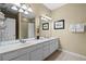 Bathroom featuring double sinks, vanity, framed art, and bath towels at 5076 Tideview Cir # 90, Orlando, FL 32819