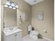 Well-lit bathroom featuring a toilet, vanity with a sink, and tile flooring for a clean and functional space at 5076 Tideview Cir # 90, Orlando, FL 32819