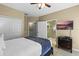 Bedroom featuring a comfortable queen bed and access to a bathroom and a walk-in closet at 5076 Tideview Cir # 90, Orlando, FL 32819