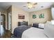 Bedroom with two beds featuring a ceiling fan and large window and TV at 5076 Tideview Cir # 90, Orlando, FL 32819
