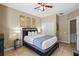 Cozy bedroom featuring a comfortable queen bed, dresser, and ample natural light from the windows at 5076 Tideview Cir # 90, Orlando, FL 32819