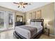 Inviting bedroom with a comfortable queen bed, dresser, and a door leading to the outside at 5076 Tideview Cir # 90, Orlando, FL 32819