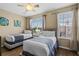 Bedroom with two beds featuring a ceiling fan and large window at 5076 Tideview Cir # 90, Orlando, FL 32819