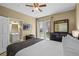 Comfortable bedroom with queen bed, dresser, ceiling fan, and access to a patio with natural light at 5076 Tideview Cir # 90, Orlando, FL 32819