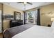 Bedroom featuring a spacious layout, ceiling fan, dark wood dresser with TV, and natural light from window at 5076 Tideview Cir # 90, Orlando, FL 32819