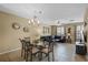 Open concept dining area with chandelier, dining table and view into the living room at 5076 Tideview Cir # 90, Orlando, FL 32819