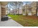 Exterior view of condos surrounded by lush green lawns and mature trees, providing a tranquil residential community at 5076 Tideview Cir # 90, Orlando, FL 32819