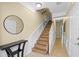 Hallway with wooden stairs, tile flooring, console table and decorative mirror at 5076 Tideview Cir # 90, Orlando, FL 32819