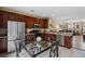 Kitchen featuring stainless steel appliances, wooden cabinets and a glass dining table at 5076 Tideview Cir # 90, Orlando, FL 32819